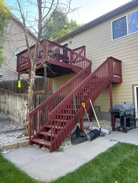 Before: deck restain in Greeley: faded red stairs
