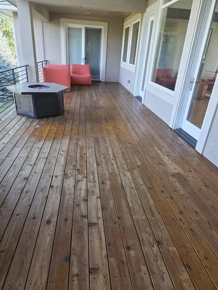 Covered wood deck with blotchy, uneven color from two stains layered on each other
