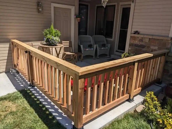 Cedar porch railing with square balusters and a matching gate