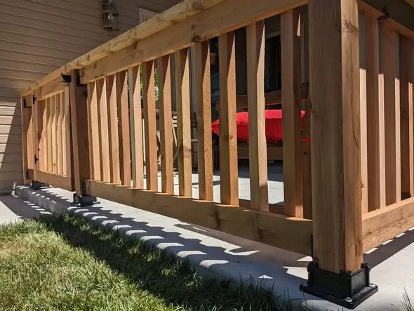 Close view of cedar railing posts and square balusters on a porch