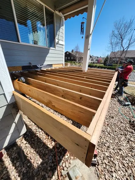 New wood deck frame with joists in place during a rebuild