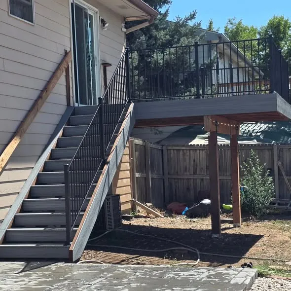 New deck stairs with metal balusters leading to an upper deck