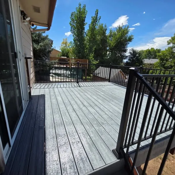New gray deck boards with a black metal railing