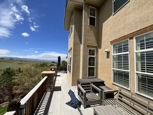 Upper deck with gray composite boards and patio furniture